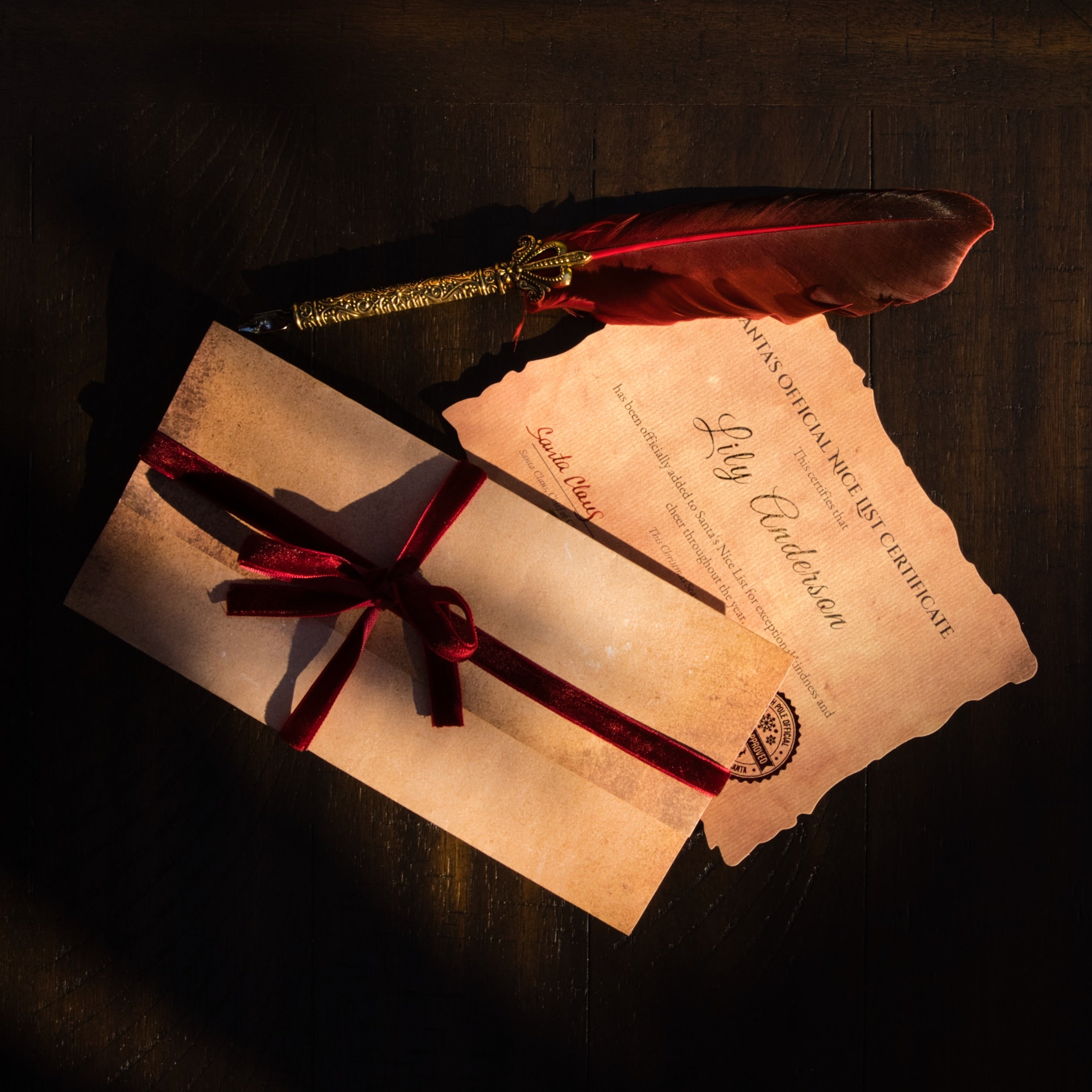 Letter from Santa Claus, Nice List Certificate and feather pen on a dark surface