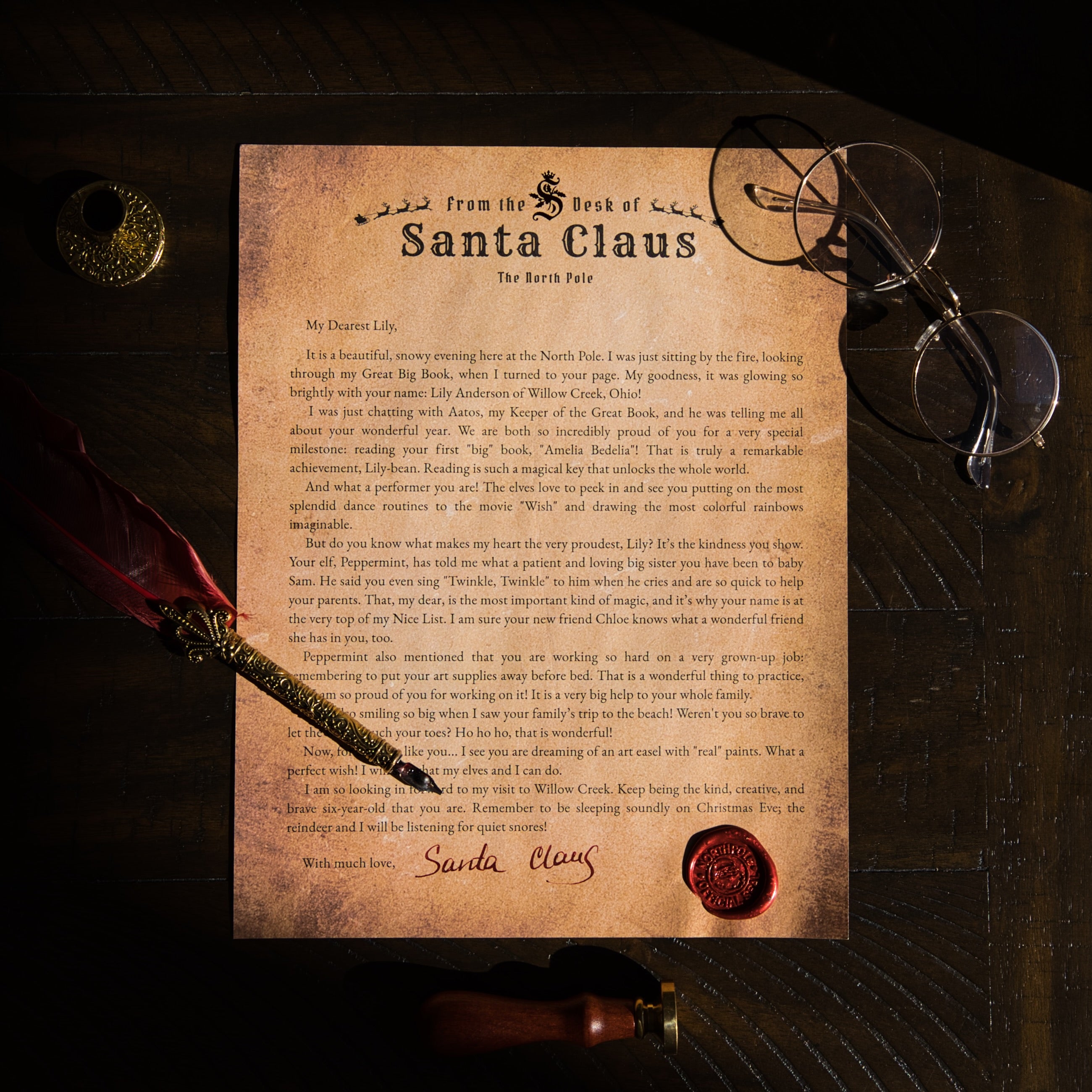 Letter from Santa Claus on a wooden surface with glasses and a quill pen.