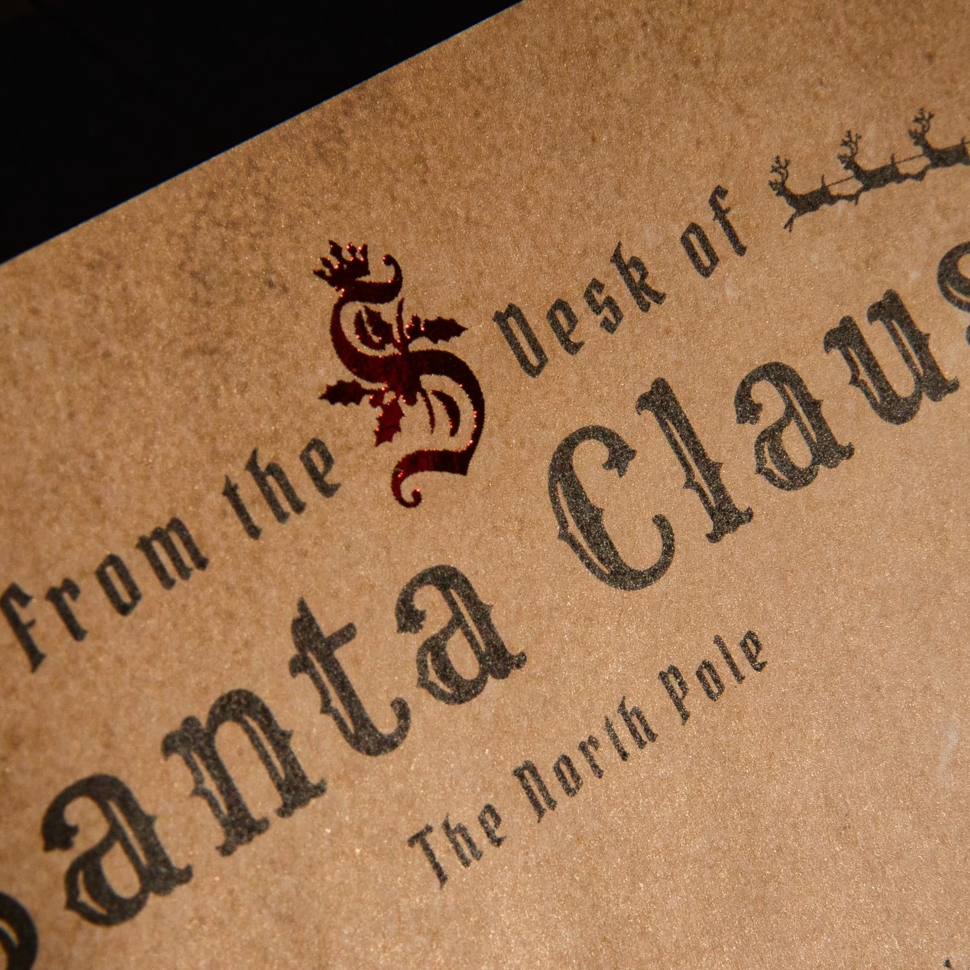 Text on a brown paper background with a decorative logo, resembling a letter from Santa Claus.